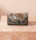 Brown cowhide and hand-tooled leather clutch with antique brass clasp
