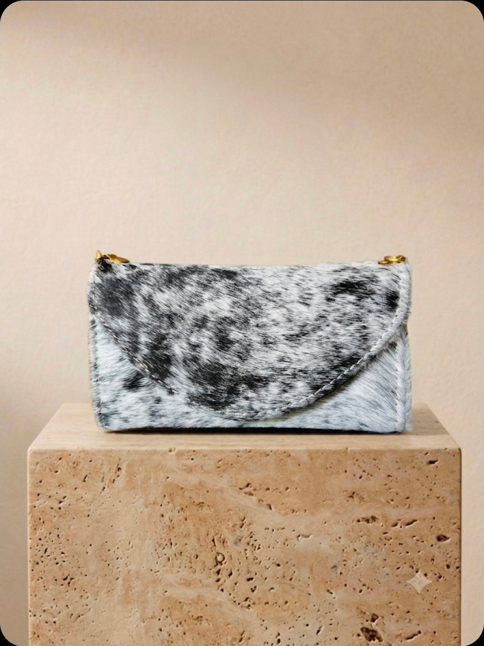 Black and white cowhide cell phone wallet purse with gold hardware and shoulder strap